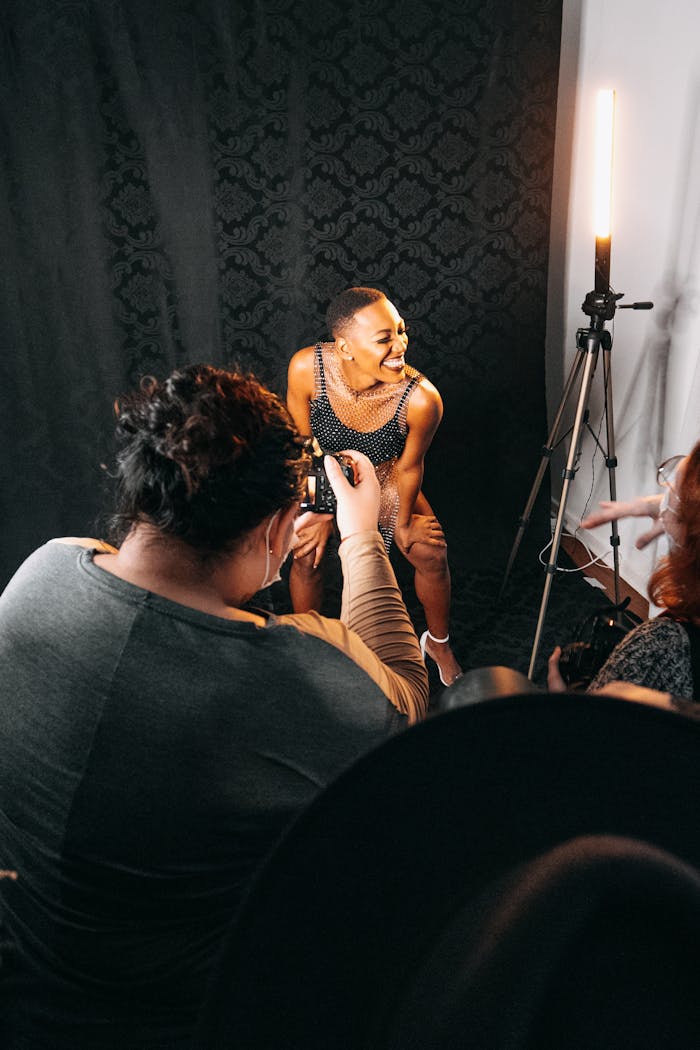 Behind-the-scenes view of a model smiling during a professional photo shoot.